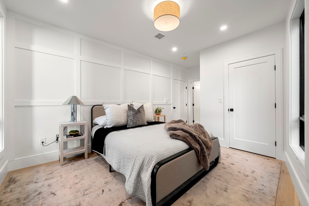 136 West 8th Street, Unit 2 Boston, MA 02127 - Photo 7 of 14 a bedroom with bed and a chandelier