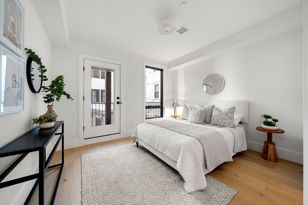 136 West 8th Street, Unit 2 Boston, MA 02127 - Photo 10 of 14 a bedroom with a bed and window