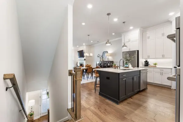 a large kitchen with a table and chairs