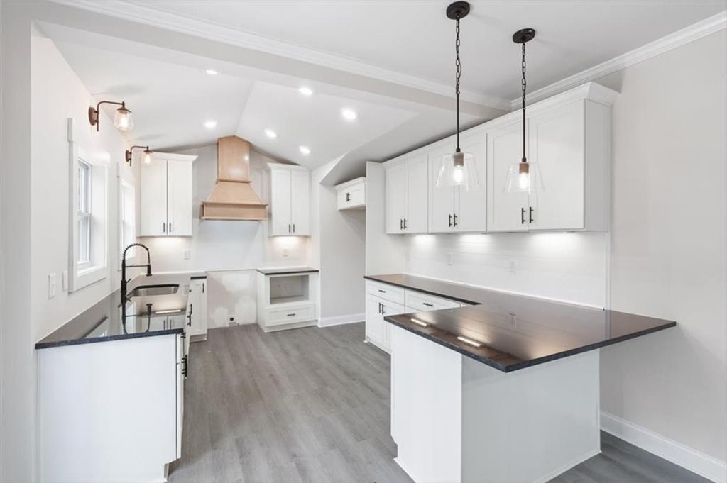 285 3rd Street East Fruithurst, AL 36262 - Photo 16 of 53 a kitchen with stainless steel appliances granite countertop a sink a stove and a wooden floors