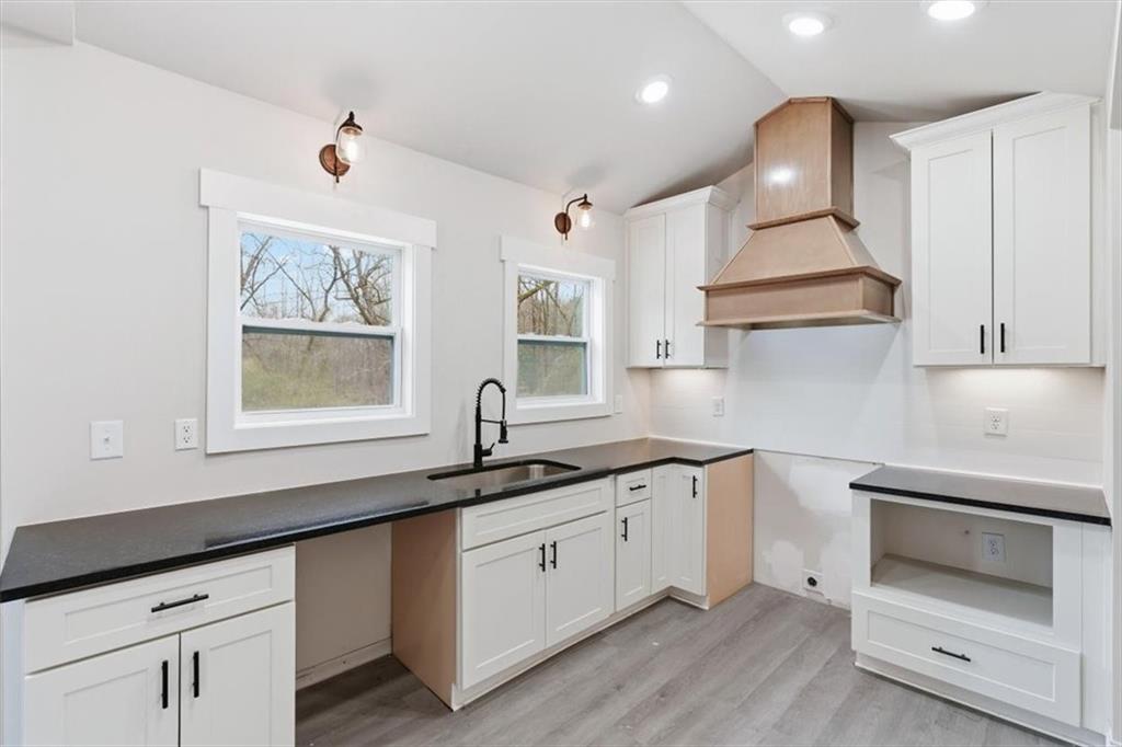 285 3rd Street East Fruithurst, AL 36262 - Photo 19 of 53 a kitchen with granite countertop white cabinets white appliances and a sink