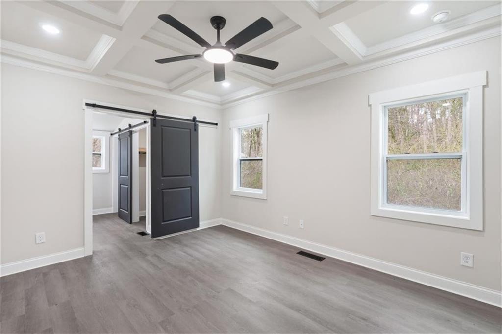 285 3rd Street East Fruithurst, AL 36262 - Photo 26 of 53 an empty room with wooden floor ceiling fan and windows