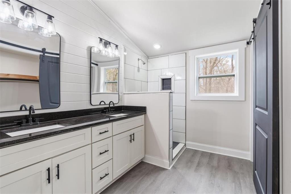 285 3rd Street East Fruithurst, AL 36262 - Photo 27 of 53 a bathroom with a double vanity sink and a mirror
