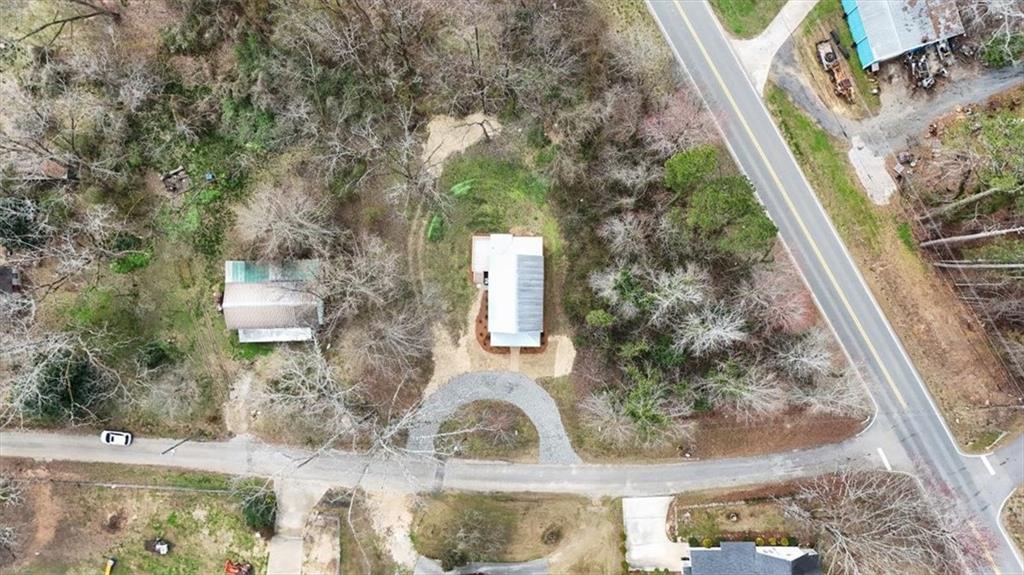 285 3rd Street East Fruithurst, AL 36262 - Photo 47 of 53 a backyard of a house with large trees and plants