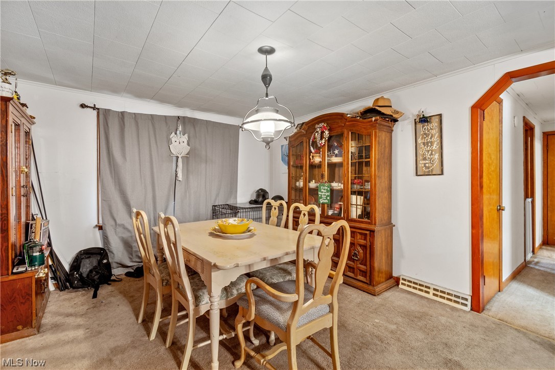 71300 Barton Road Bridgeport, OH 43912 - Photo 9 of 25 Carpeted dining area with a baseboard heating unit and crown molding