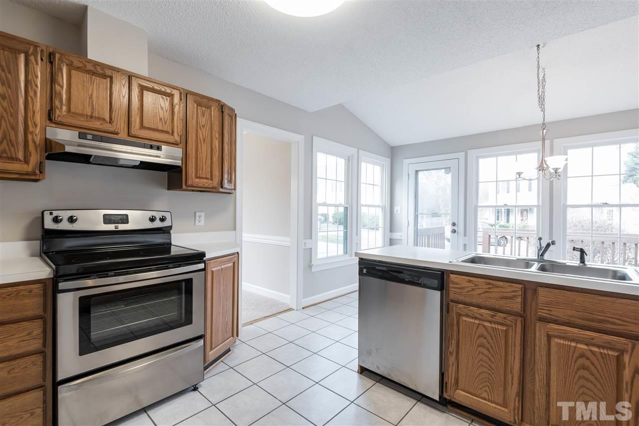 4237 Dinwiddie Court Raleigh, NC 27604 - Photo 12 of 25 a kitchen with stainless steel appliances granite countertop a sink and cabinets