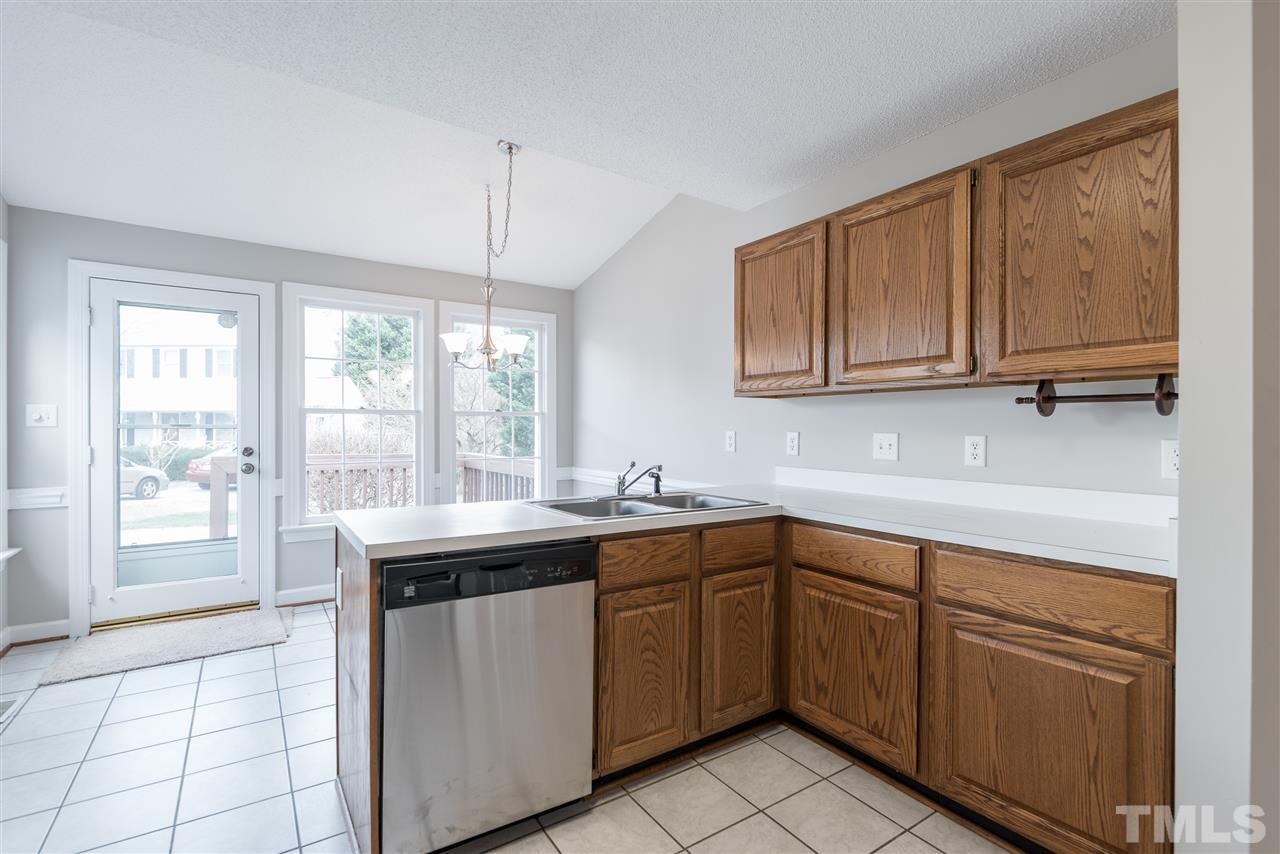 4237 Dinwiddie Court Raleigh, NC 27604 - Photo 13 of 25 a kitchen with a sink window and cabinets