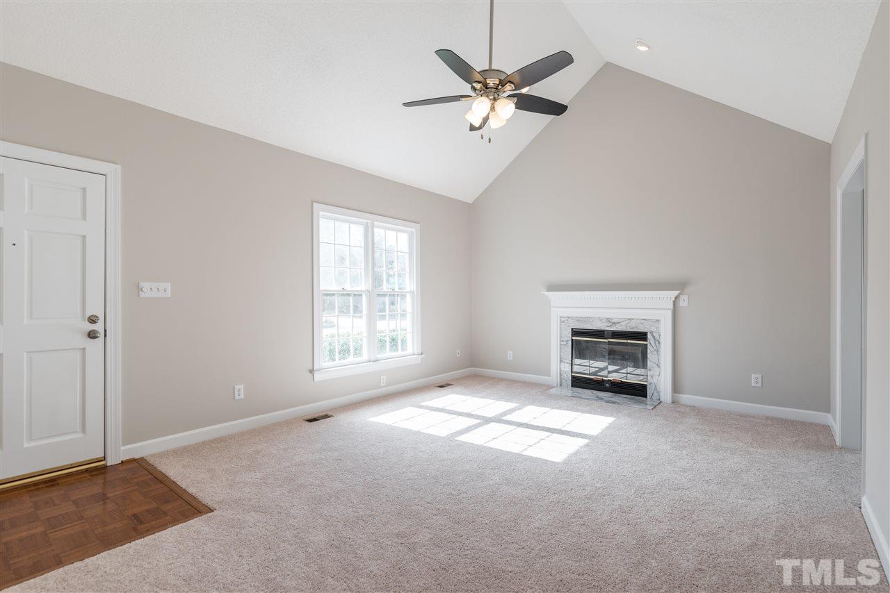 4237 Dinwiddie Court Raleigh, NC 27604 - Photo 4 of 25 an empty room with windows and fireplace