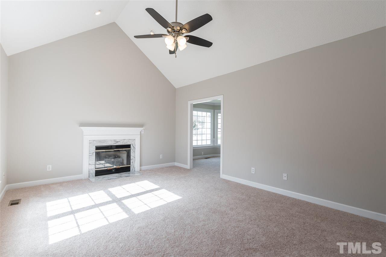 4237 Dinwiddie Court Raleigh, NC 27604 - Photo 5 of 25 an empty room with windows and fireplace