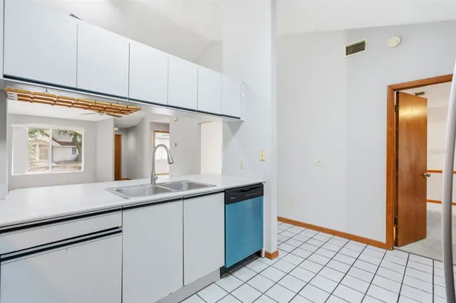 a kitchen with a sink and a refrigerator