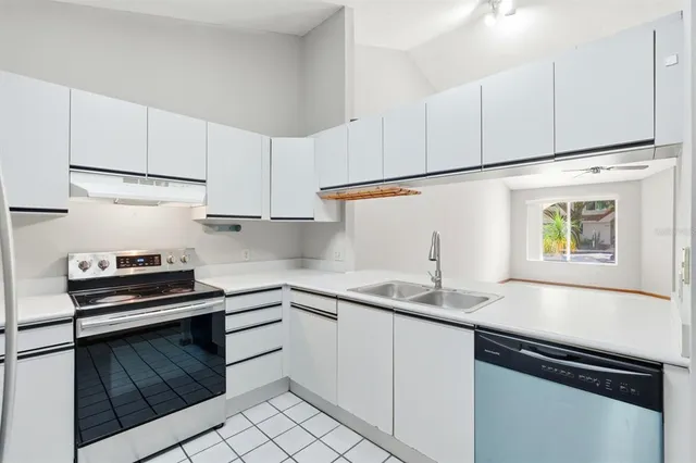 a kitchen with a sink and a stove top oven