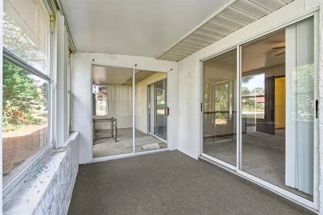 a big room with wooden floor and windows