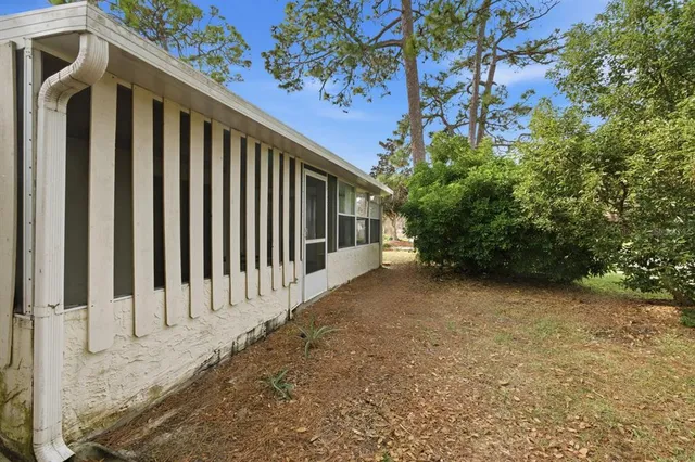 a view of wooden house with a yard