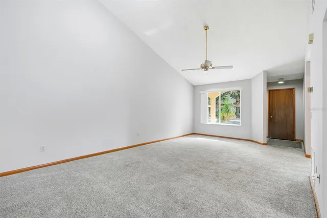 an empty room with windows and entrance