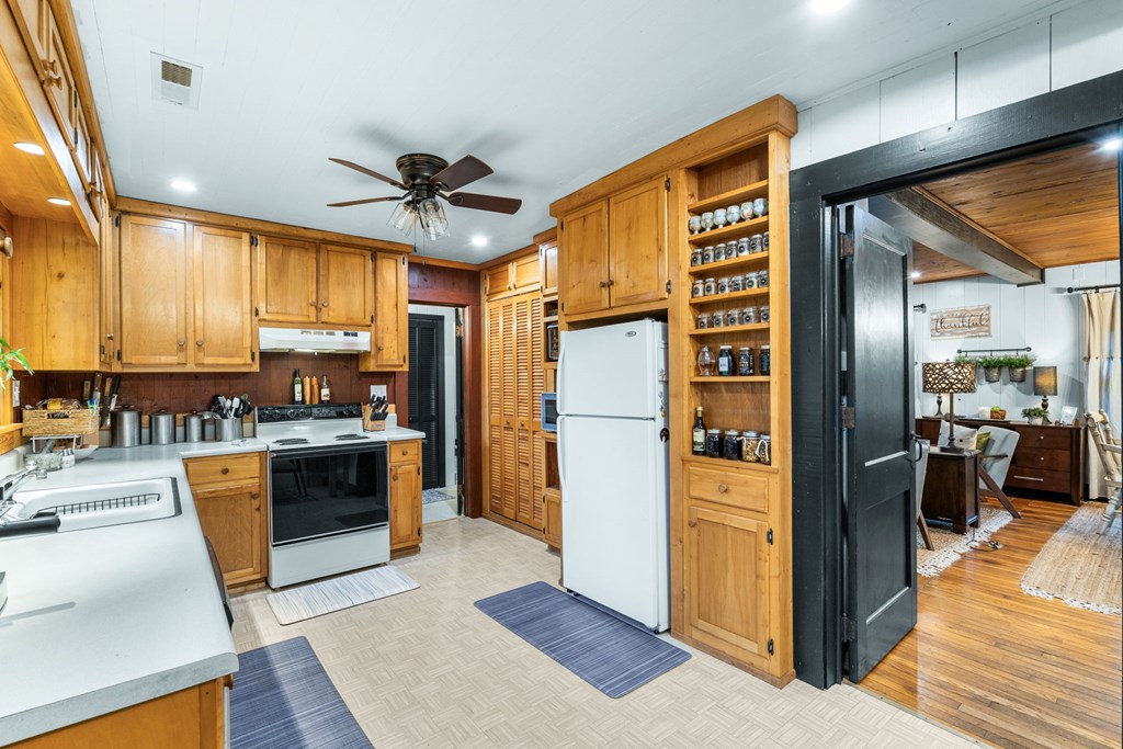 106 Settawig Road Brasstown, NC 28902 - Photo 12 of 100 a kitchen with stainless steel appliances granite countertop a refrigerator and a stove