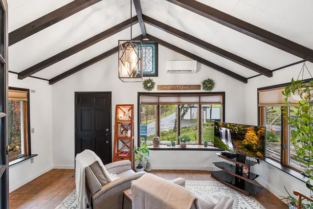 a living room with furniture and floor to ceiling windows