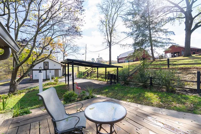 a view of a house with a yard swing and slide