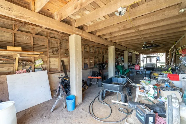 a backyard of a house with barbeque oven table and chairs