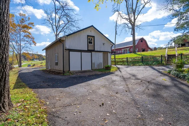 a view of a house with a yard and sitting area