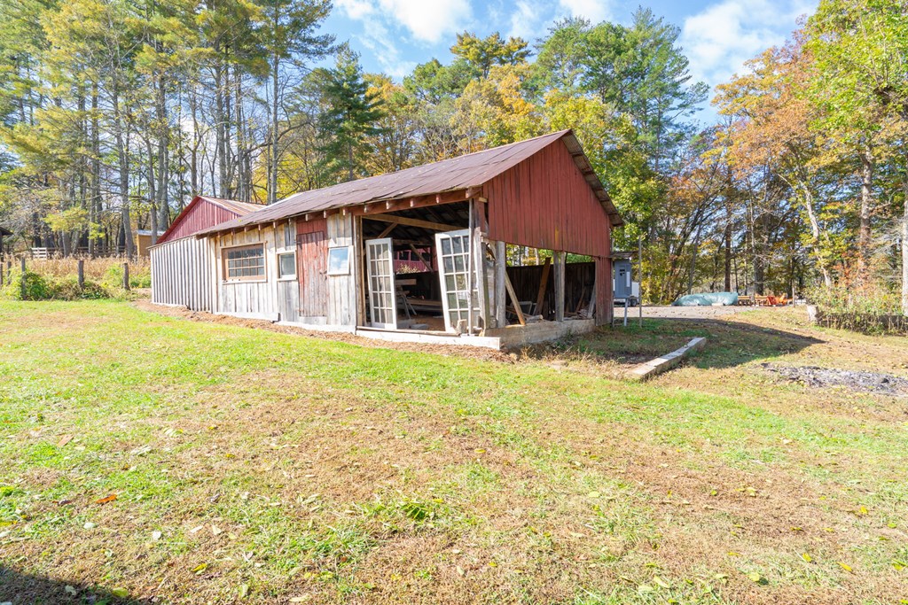 106 Settawig Road Brasstown, NC 28902 - Photo 48 of 100 a view of a house with a yard and large tree