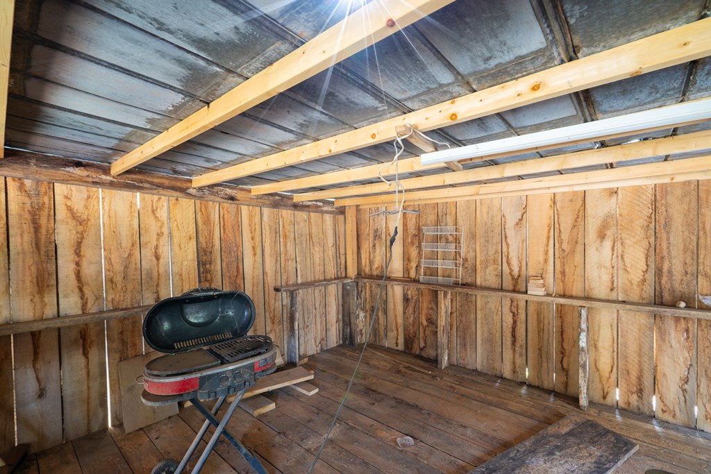 106 Settawig Road Brasstown, NC 28902 - Photo 50 of 100 a utility room with wooden floor and furniture