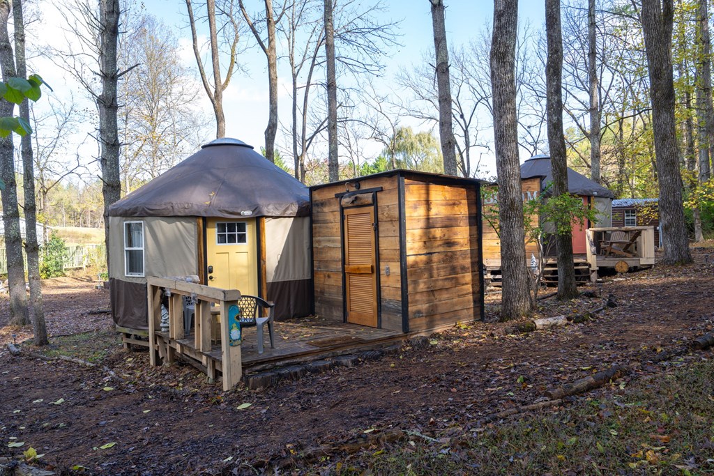 106 Settawig Road Brasstown, NC 28902 - Photo 67 of 100 a view of a house with a yard swing and slide