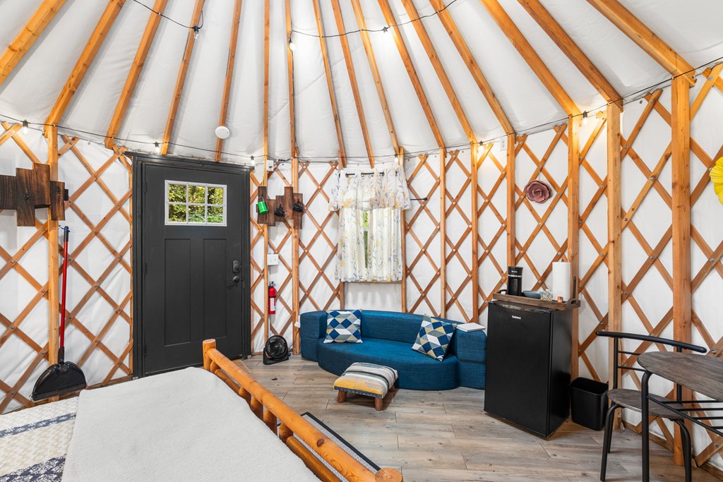 106 Settawig Road Brasstown, NC 28902 - Photo 89 of 100 a bedroom with a bed and a chandelier