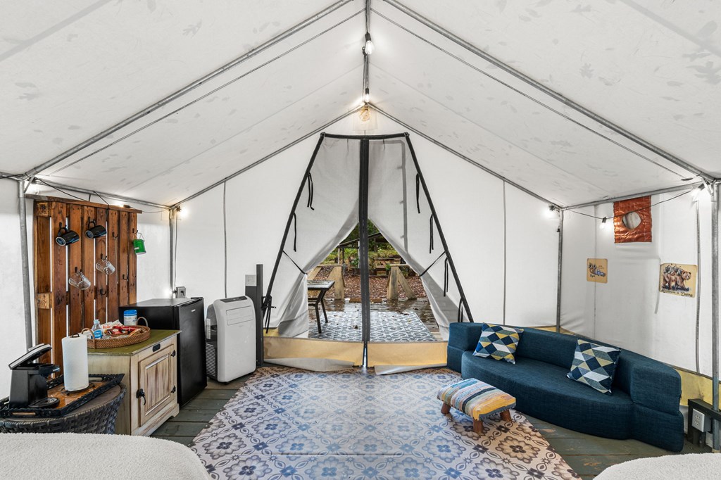 106 Settawig Road Brasstown, NC 28902 - Photo 97 of 100 a living room with furniture a rug and a chandelier