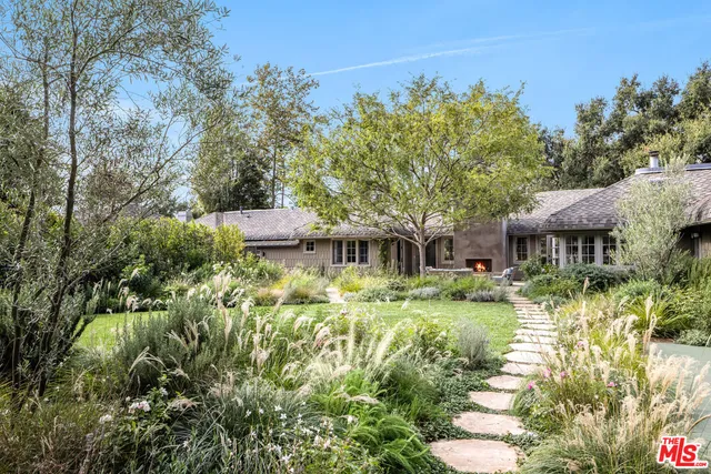 a backyard of a house with yard swimming pool and outdoor seating