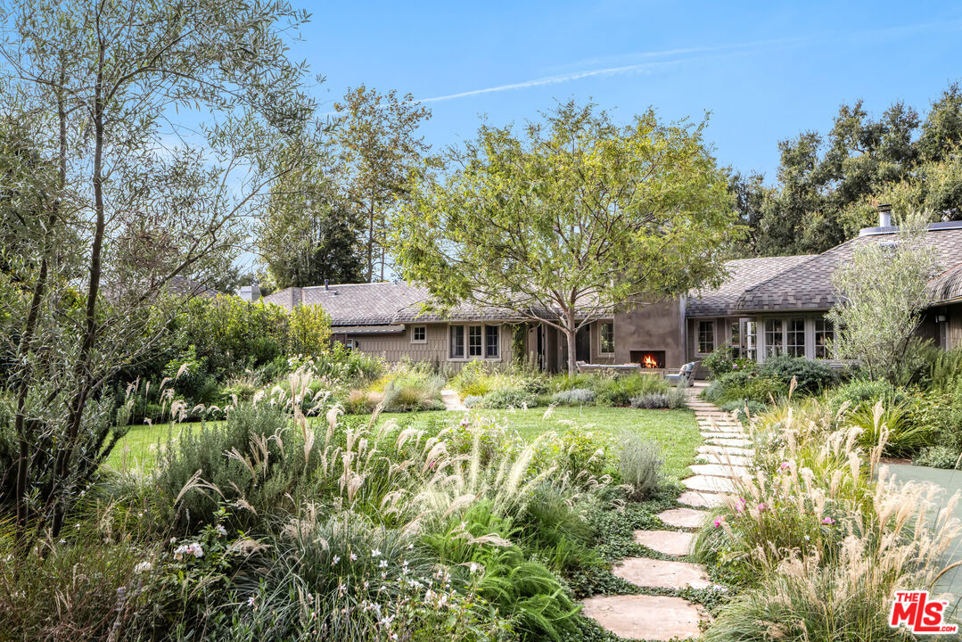 a backyard of a house with yard swimming pool and outdoor seating