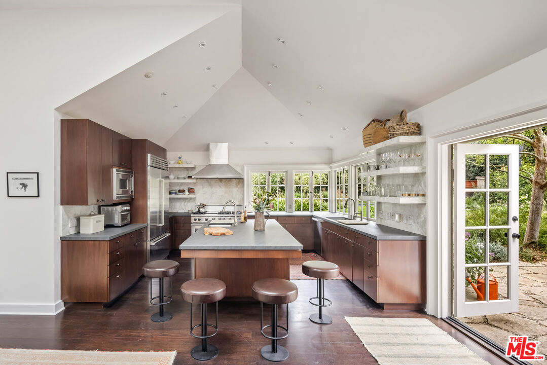 7 Latimer Road Santa Monica, CA 90402 - Photo 13 of 37 a room with stainless steel appliances kitchen island granite countertop furniture and a large window