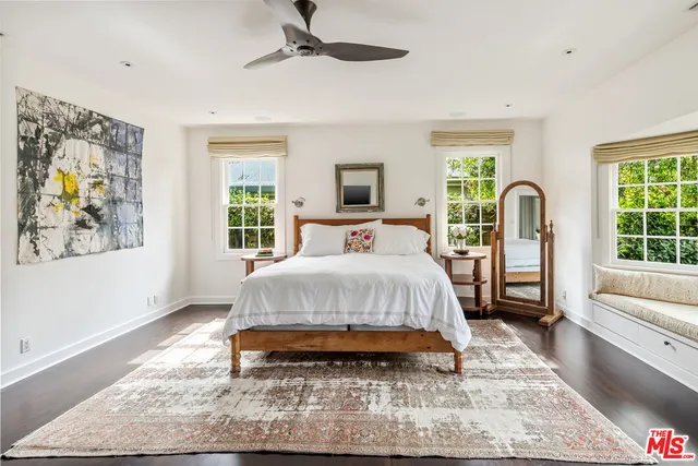 a spacious bedroom with a bed a couch and a window