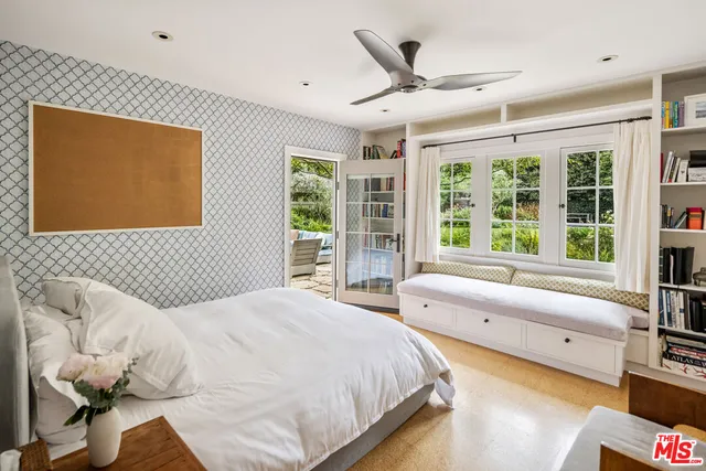 a bedroom with a large bed and a large window