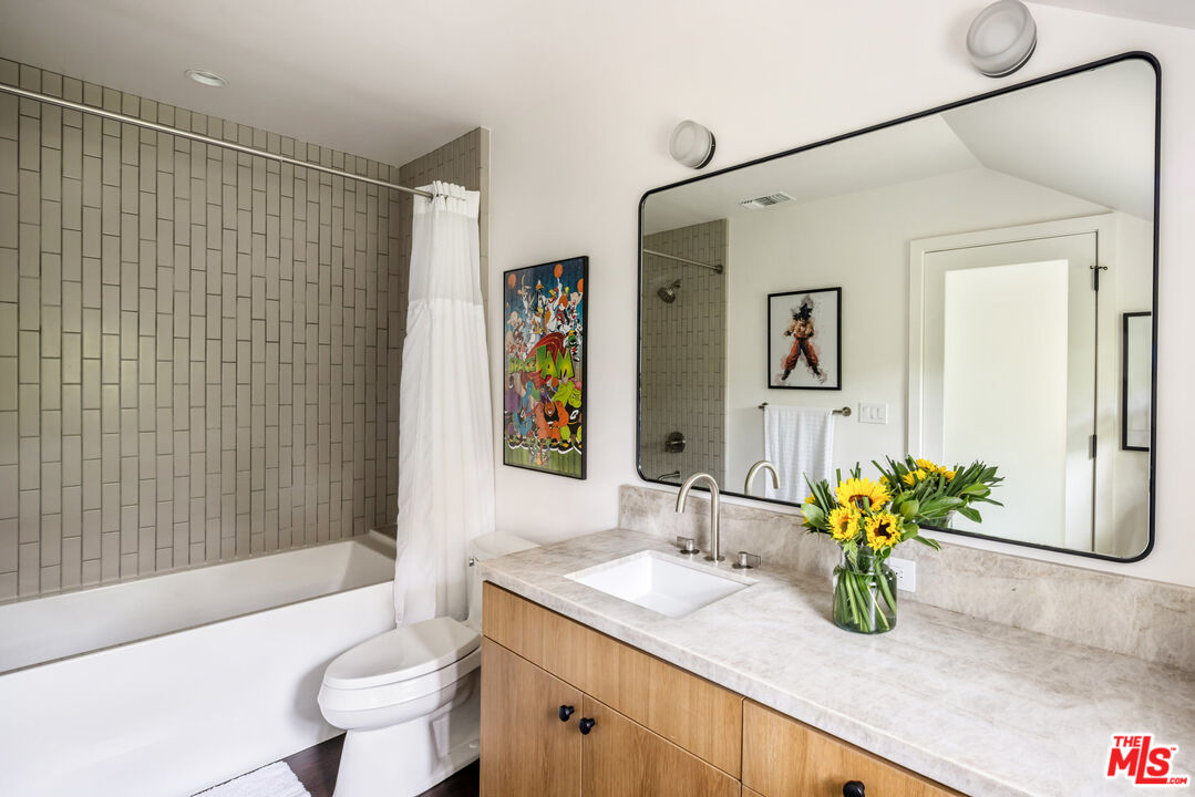 7 Latimer Road Santa Monica, CA 90402 - Photo 22 of 37 a bathroom with a granite countertop sink a toilet and shower