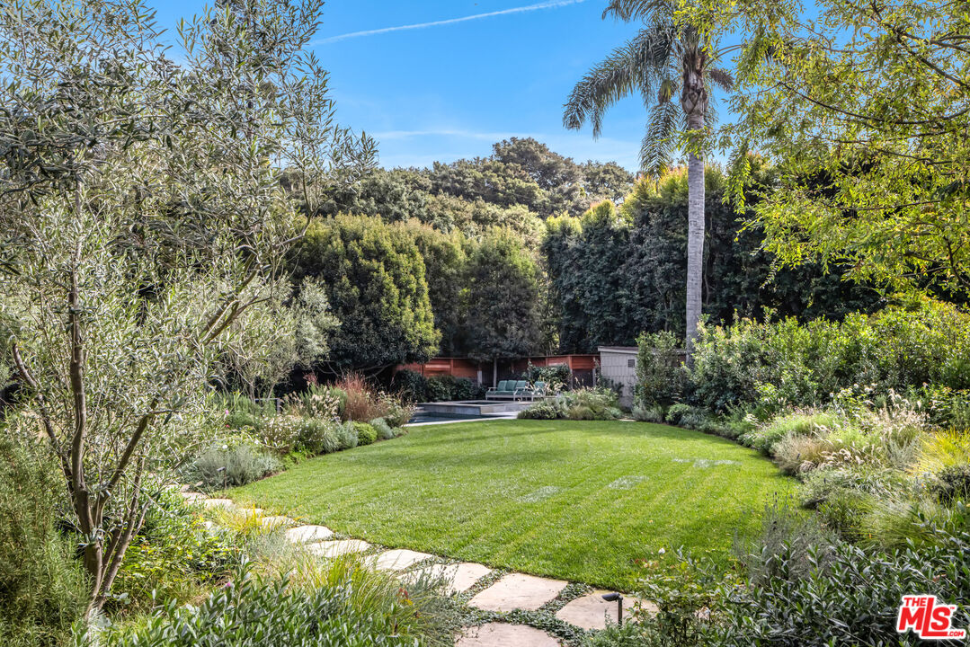 7 Latimer Road Santa Monica, CA 90402 - Photo 25 of 37 a view of a chair and tables in the backyard of the house
