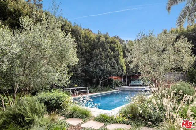 a view of a swimming pool with a yard