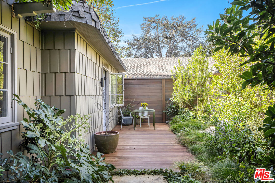 7 Latimer Road Santa Monica, CA 90402 - Photo 28 of 37 a view of a patio with table and chairs potted plants and large tree