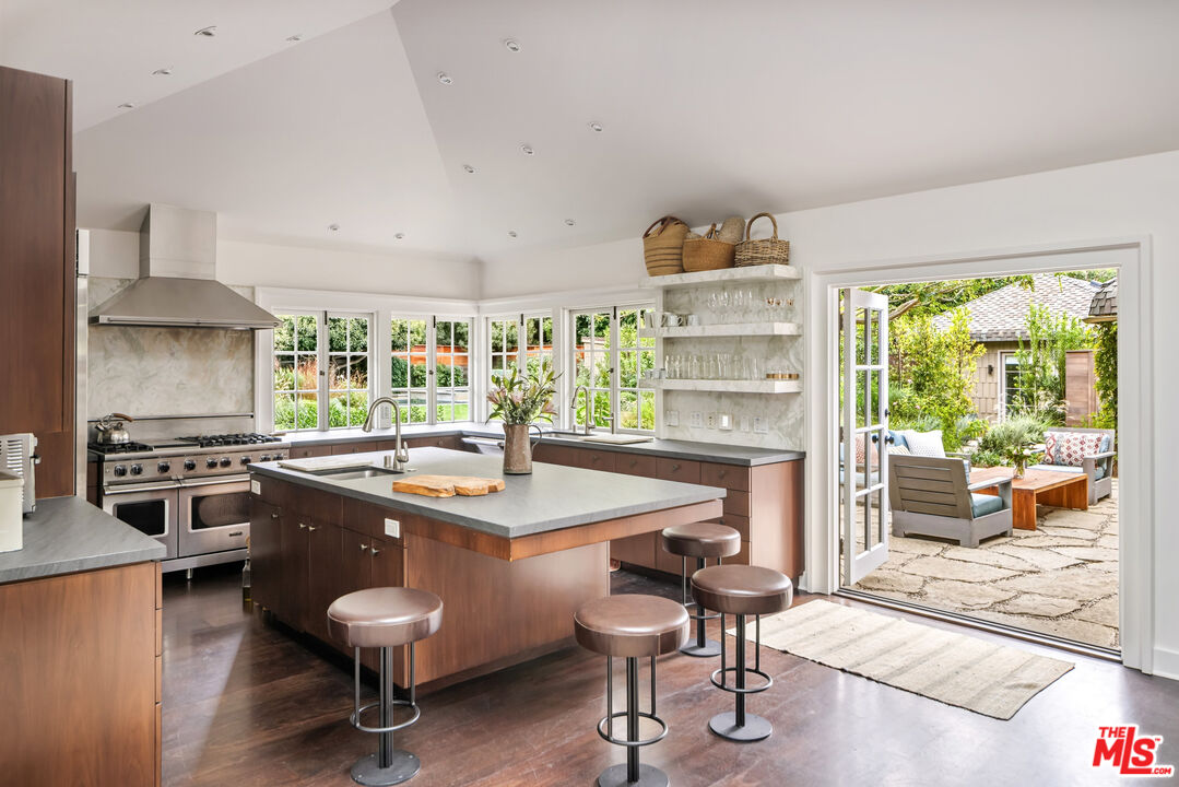 7 Latimer Road Santa Monica, CA 90402 - Photo 10 of 37 a kitchen with a stove a refrigerator and chairs