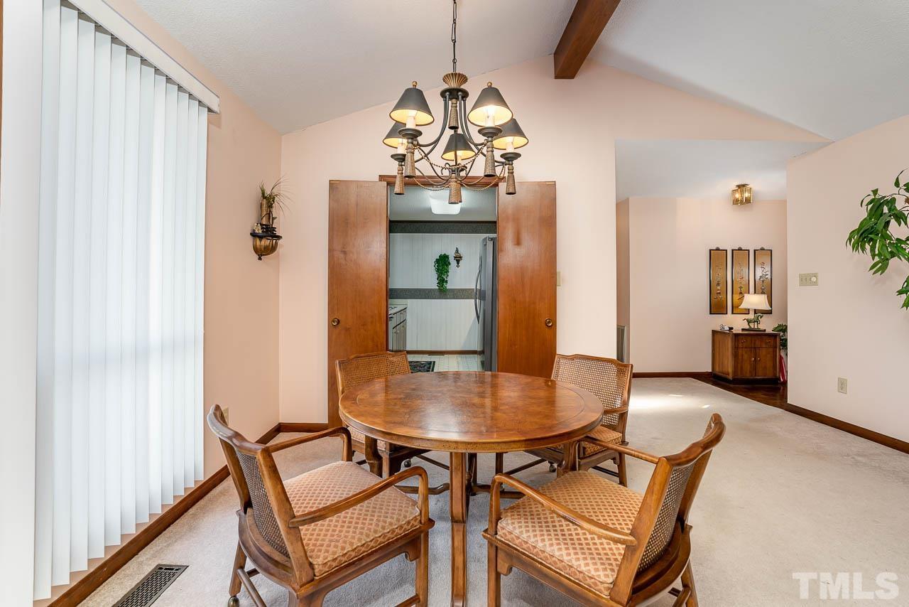 2745 Rue Sans Famille Raleigh, NC 27607 - Photo 7 of 15 a view of a dining room with furniture and wooden floor
