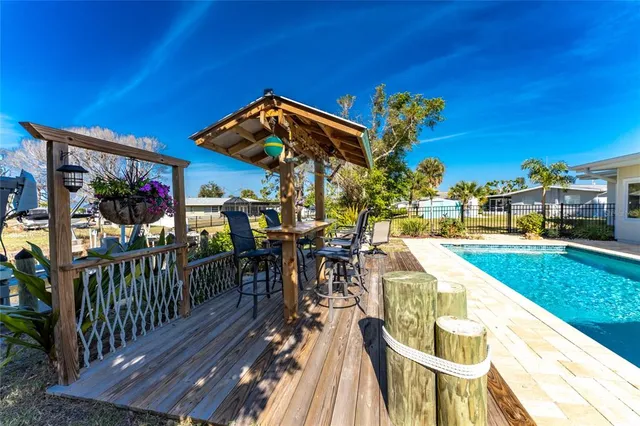 a view of a patio with table and chairs potted plants with wooden fence