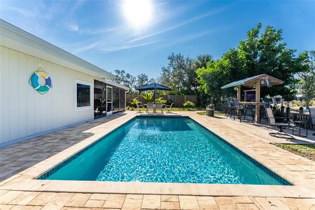 a view of swimming pool with chairs