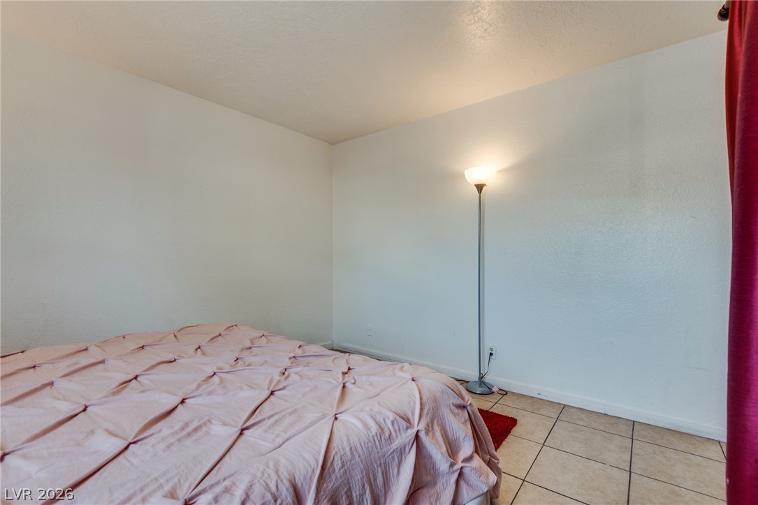 5829 Smoke Ranch Road, Unit D Las Vegas, NV 89108 - Photo 23 of 27 Smooth tiled floors and clean plaster walls define this versatile interior space.