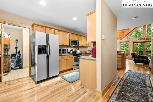 a kitchen that has a refrigerator and a stove