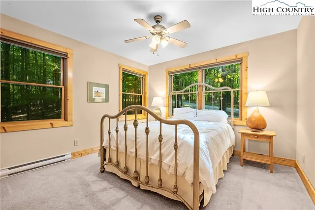 a spacious bedroom with a bed and a table