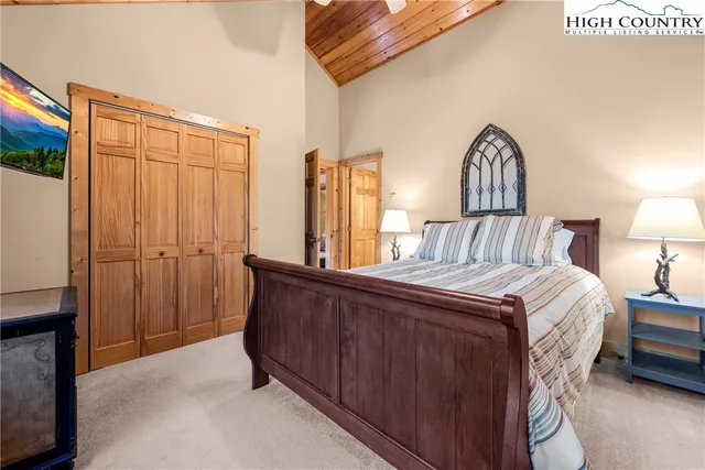 a bedroom with a bed lamp and a window