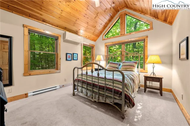 a bedroom with a bed a table and window