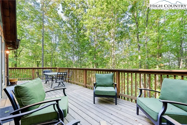 a view of a chairs and table on the wooden deck