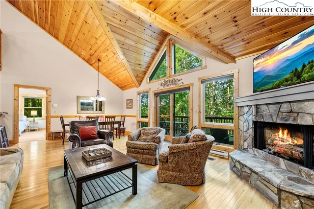 a living room with furniture a fireplace and a large window