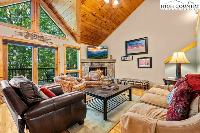 a living room with furniture a large window with outer view