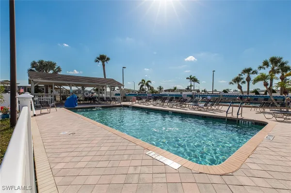 a view of swimming pool with outdoor seating
